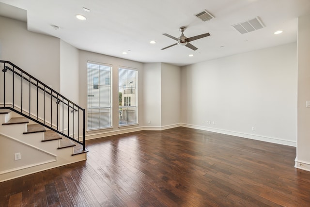 empty room with ceiling fan and dark hardwood / wood-style flooring