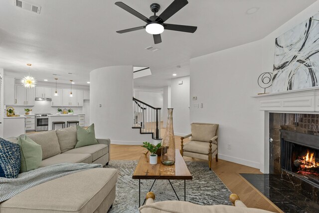 dining space with a chandelier, ornamental molding, and light hardwood / wood-style flooring