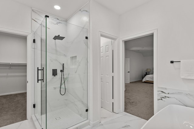 full bathroom featuring a marble finish shower, connected bathroom, marble finish floor, a freestanding tub, and recessed lighting