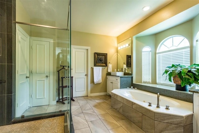 bathroom with vanity, tile patterned floors, and separate shower and tub