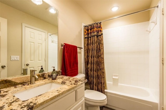 full bathroom with vanity, shower / tub combo, and toilet