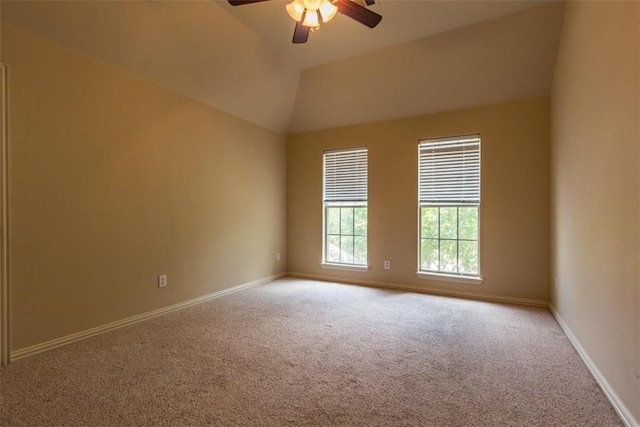 carpeted spare room featuring ceiling fan and vaulted ceiling