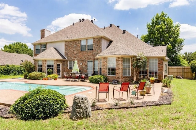 view of pool with a lawn and a patio area