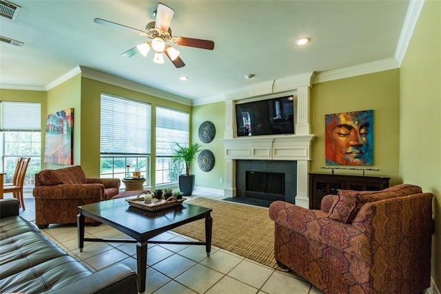 tiled living room featuring crown molding and plenty of natural light