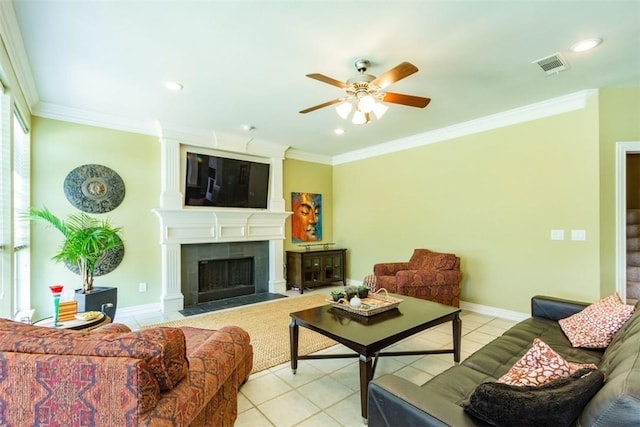 living room featuring light tile patterned floors, ornamental molding, a tile fireplace, and ceiling fan