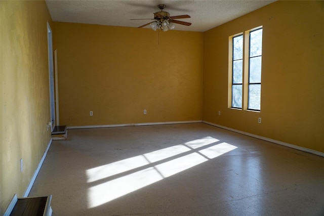 spare room with ceiling fan and a textured ceiling