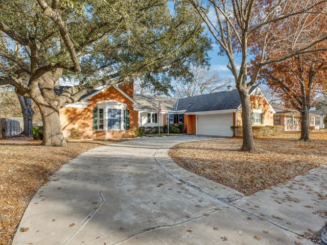 ranch-style home featuring an attached garage and concrete driveway