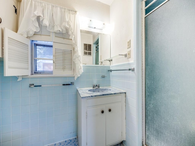 bathroom with vanity and tile walls