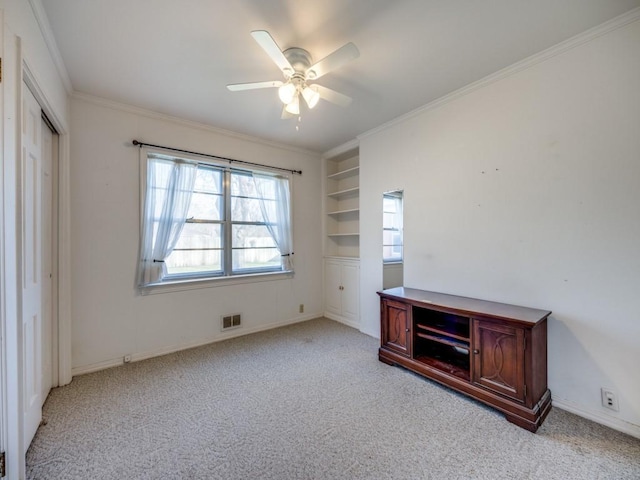 unfurnished bedroom with light carpet, ornamental molding, visible vents, and a ceiling fan