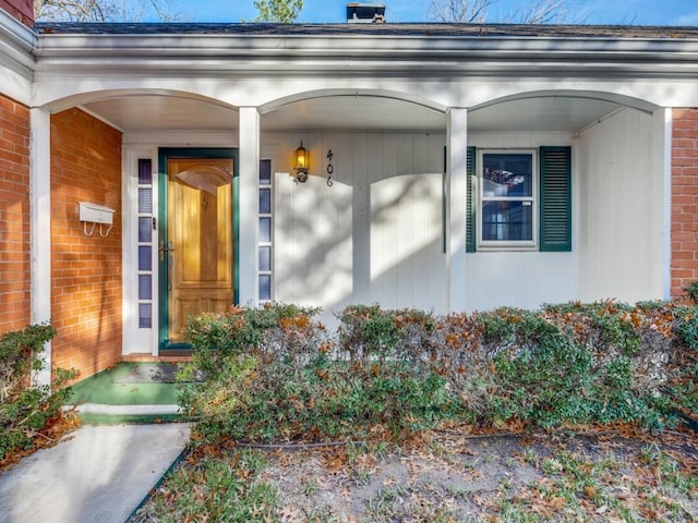 property entrance featuring brick siding