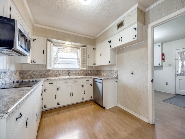 kitchen featuring light countertops, appliances with stainless steel finishes, white cabinetry, and crown molding