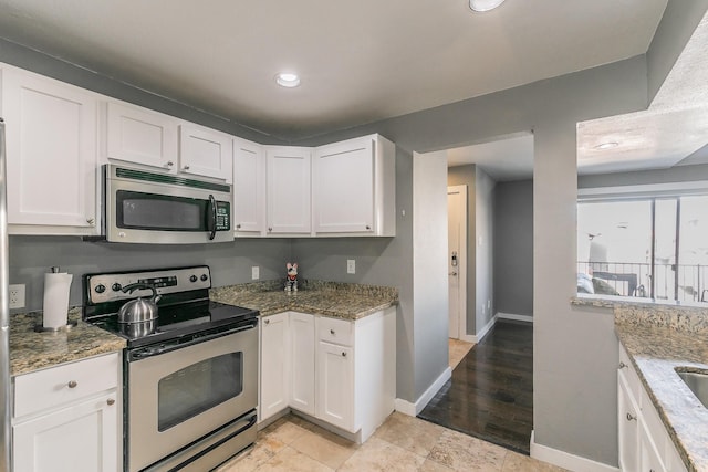 kitchen with white cabinets, stainless steel appliances, and stone countertops