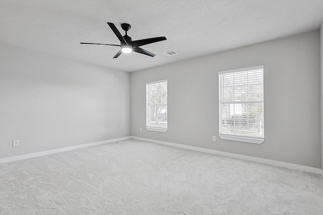 empty room with light carpet and ceiling fan