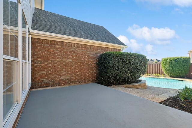 view of patio / terrace with a fenced in pool