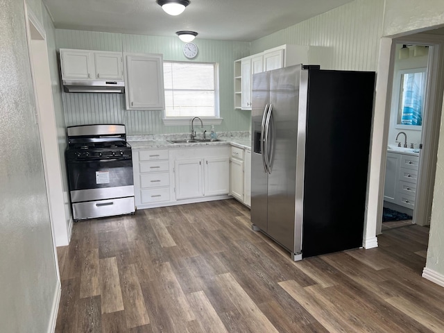 kitchen featuring sink, dark wood-type flooring, stainless steel appliances, and white cabinets