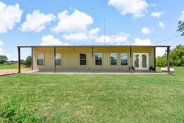 back of property with french doors and a yard