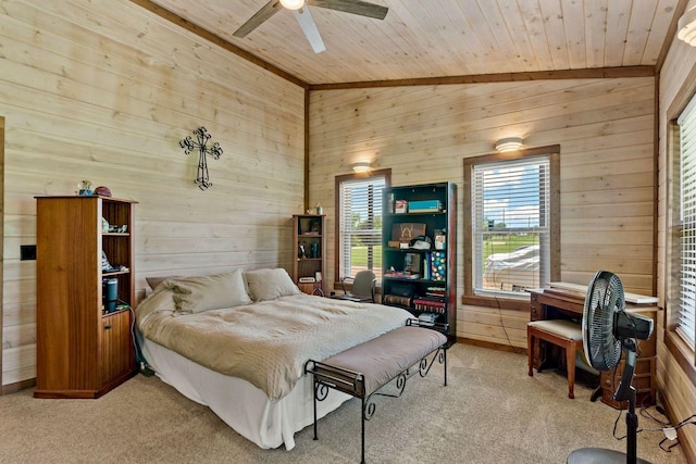 bedroom with wood ceiling, light colored carpet, vaulted ceiling, ceiling fan, and wooden walls