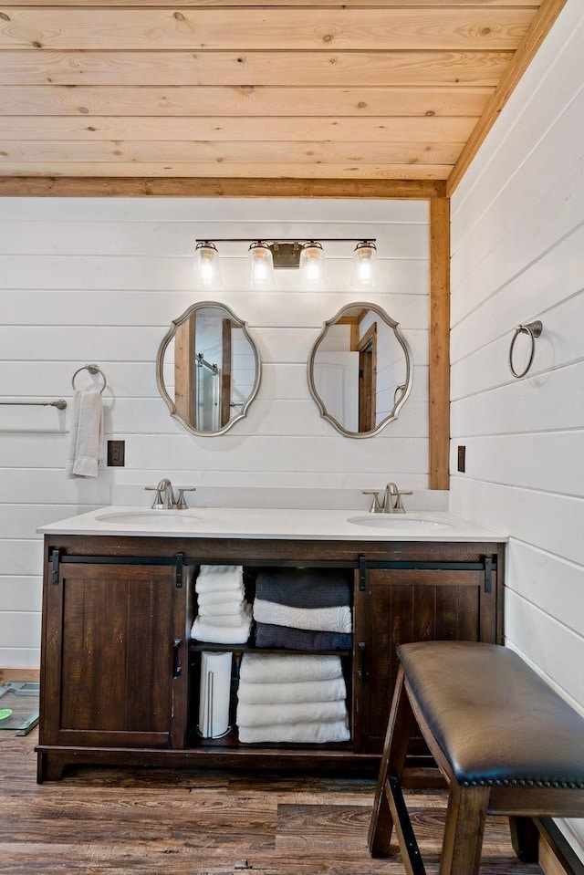 bathroom featuring wood walls, vanity, wooden ceiling, and hardwood / wood-style flooring