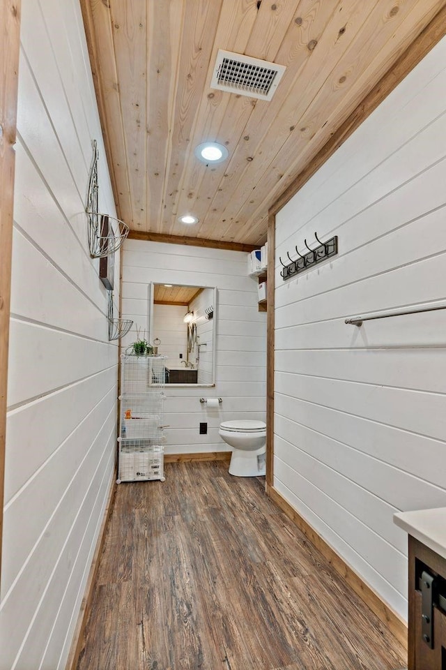 bathroom with hardwood / wood-style floors, wood walls, and wood ceiling