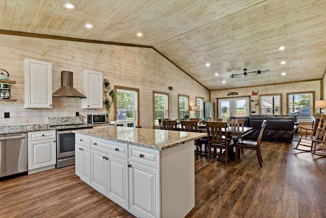 kitchen with wooden ceiling, wall chimney range hood, dark hardwood / wood-style floors, white cabinetry, and stainless steel appliances