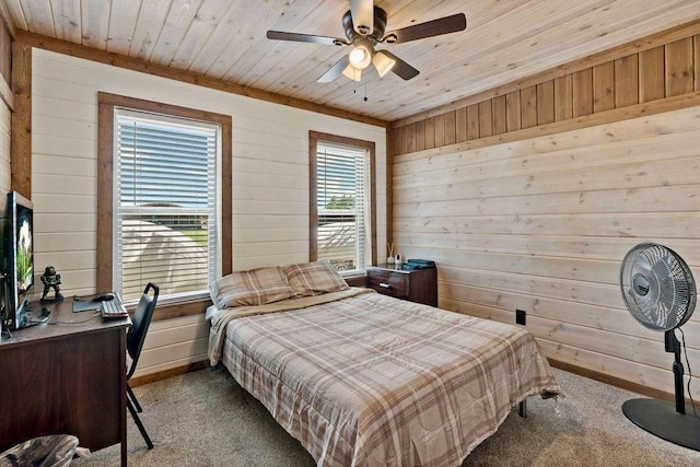 carpeted bedroom with ceiling fan, wooden walls, and wood ceiling