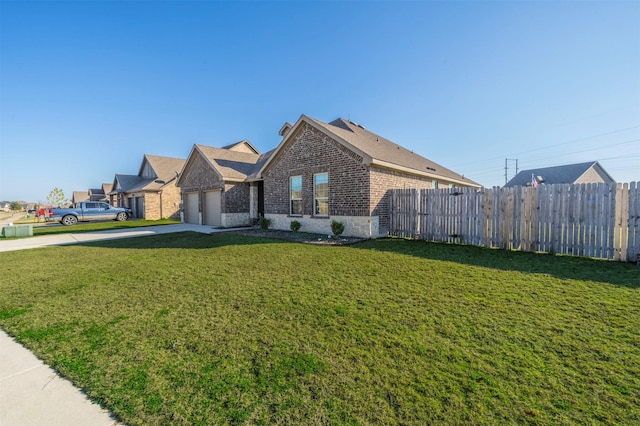 view of side of property with a yard and a garage