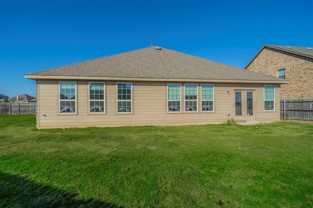 back of property featuring a yard