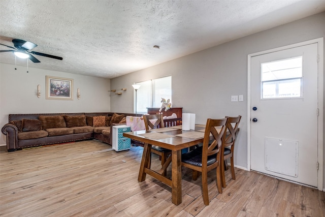 dining area featuring a textured ceiling, light hardwood / wood-style floors, and plenty of natural light