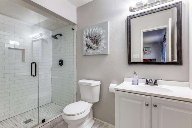 bathroom featuring vanity, toilet, and walk in shower