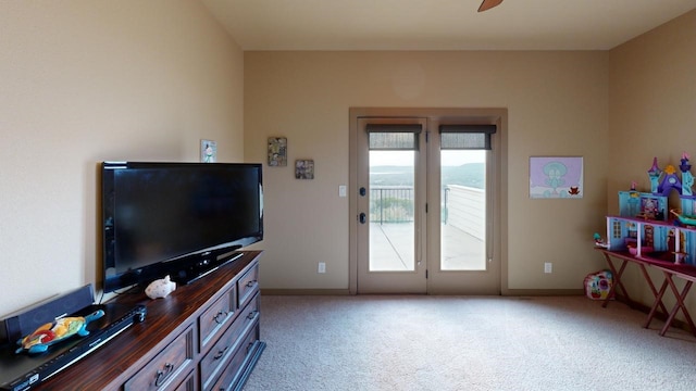 interior space featuring ceiling fan and light carpet