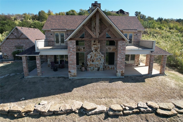 craftsman inspired home with a patio area and a balcony