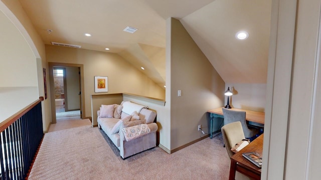 carpeted office space with vaulted ceiling