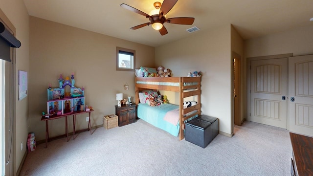 bedroom with ceiling fan, carpet floors, and a closet