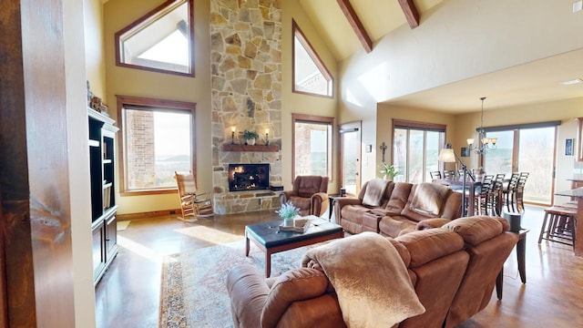 living room with an inviting chandelier, a fireplace, high vaulted ceiling, and beamed ceiling