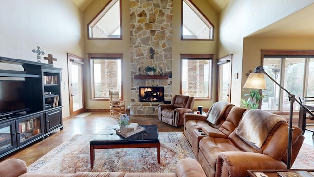 living room featuring a fireplace and a high ceiling