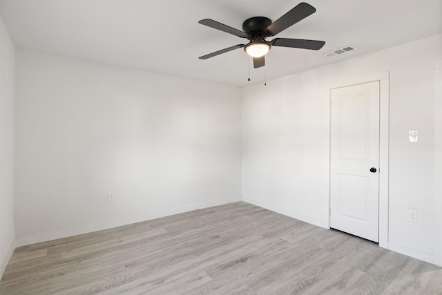 spare room with ceiling fan and light wood-type flooring