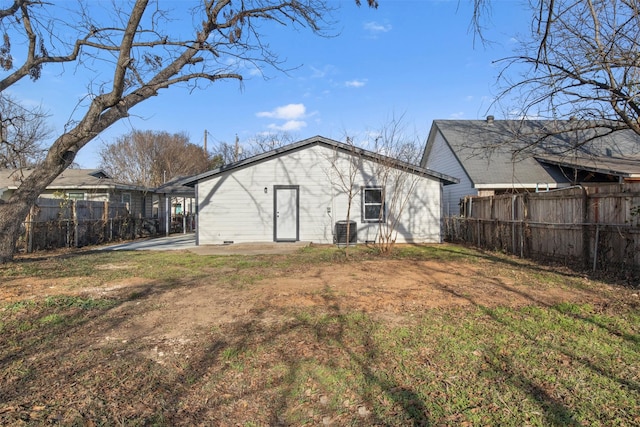 rear view of house featuring cooling unit, a patio area, and a yard