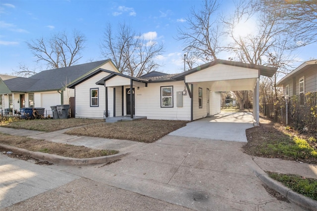 ranch-style home with a garage and a carport