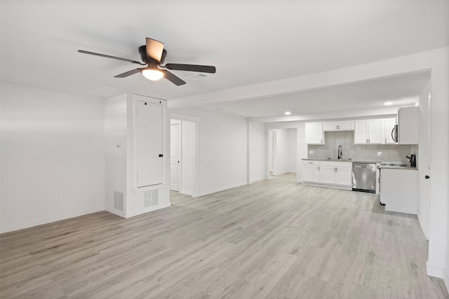 unfurnished living room featuring ceiling fan, light wood-type flooring, and sink