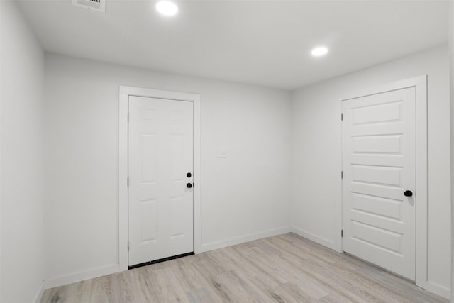 spare room with light hardwood / wood-style floors