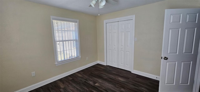 unfurnished bedroom featuring ceiling fan, a closet, and dark hardwood / wood-style floors