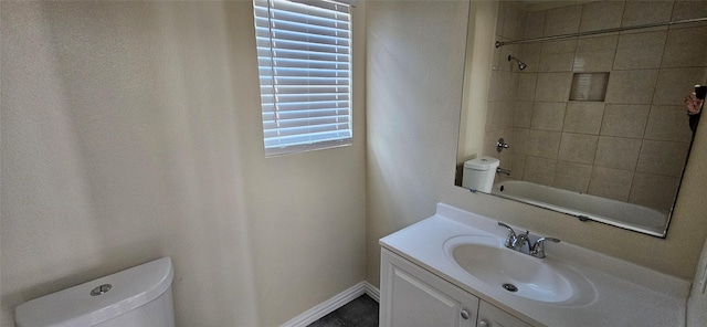 full bathroom featuring tile patterned flooring, vanity, tiled shower / bath combo, and toilet