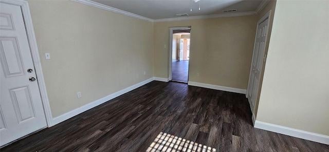 spare room with dark hardwood / wood-style flooring and crown molding