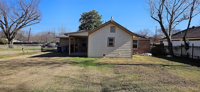 back of property featuring a yard