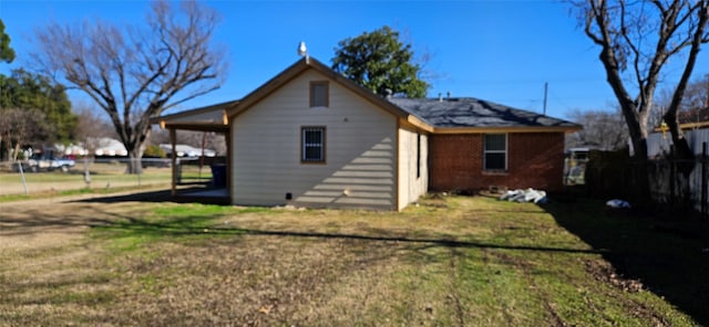 rear view of property with a yard