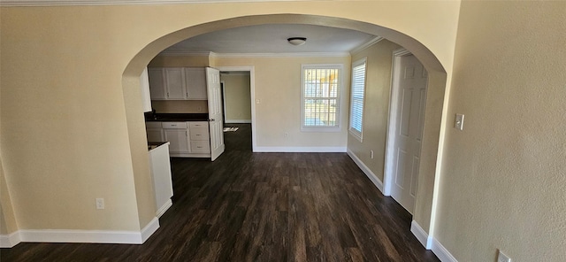 corridor featuring crown molding and dark wood-type flooring