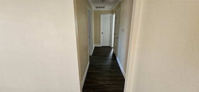 hallway featuring dark hardwood / wood-style flooring and crown molding