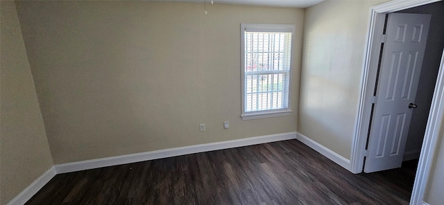 unfurnished room with dark hardwood / wood-style flooring