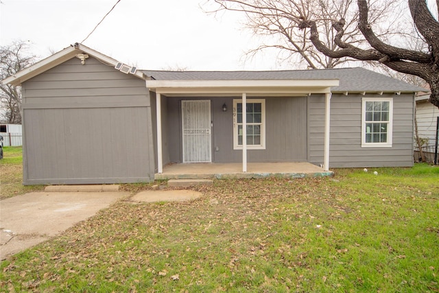 ranch-style house featuring a porch and a front lawn