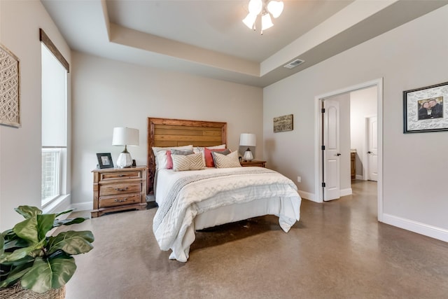 bedroom with ceiling fan and a tray ceiling